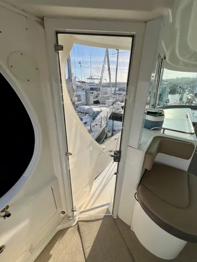 Reflections Yacht Photos Pics Interior view of 2005 Sea Ray 390 Motor Yacht, showing door and seating area.