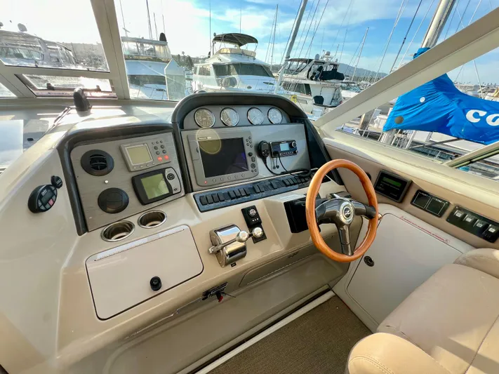 Reflections Yacht Photos Pics 2005 Sea Ray 390 Motor Yacht helm with navigation instruments and wooden steering wheel.