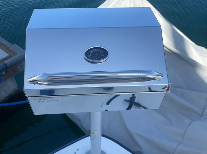 Reflections Yacht Photos Pics Stainless steel grill on a 2005 Sea Ray 390 Motor Yacht, docked by the water.