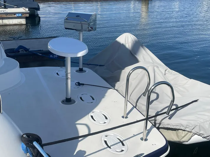 Reflections Yacht Photos Pics 2005 Sea Ray 390 Motor Yacht deck with ladder and covered equipment at marina.