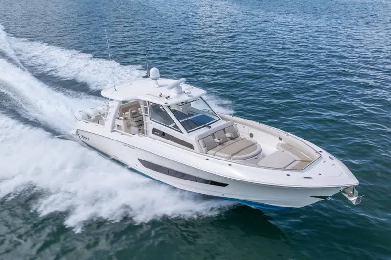  Yacht Photos Pics 2018 Boston Whaler 420 Outrage cruising on open water, showcasing sleek design and performance.
