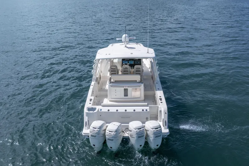  Yacht Photos Pics 2018 Boston Whaler 420 Outrage cruising on open water, rear view.