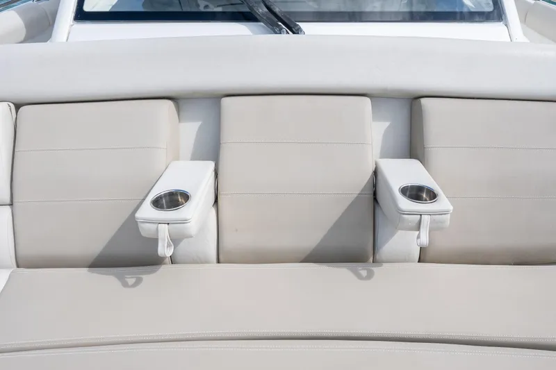  Yacht Photos Pics 2018 Boston Whaler 420 Outrage boat seating with cup holders, featuring beige upholstery.