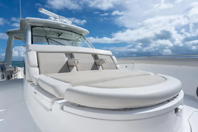  Yacht Photos Pics 2018 Boston Whaler 420 Outrage boat with luxurious seating under a blue sky.