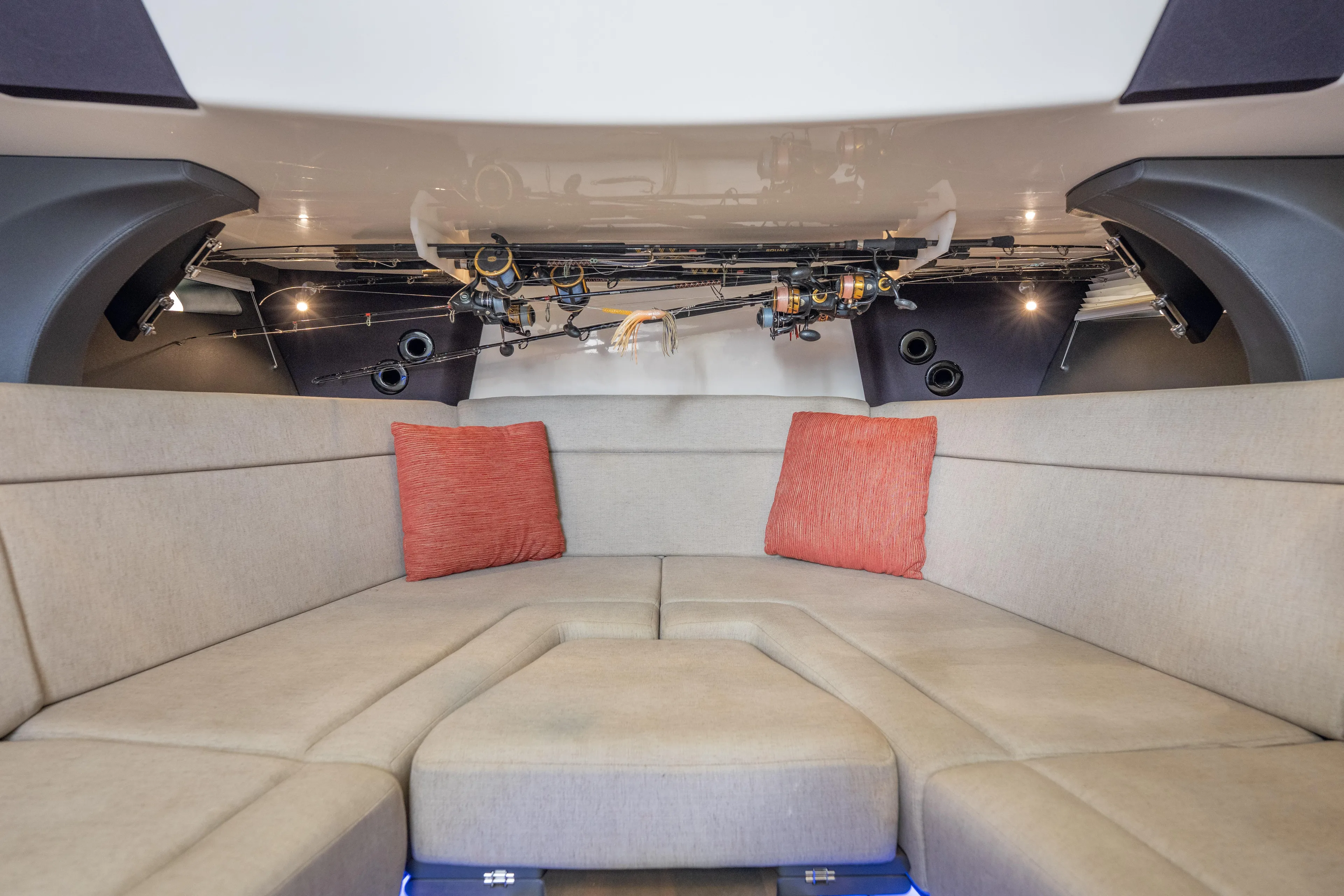  Yacht Photos Pics 2018 Boston Whaler 420 Outrage cabin with beige seating and fishing rods overhead.