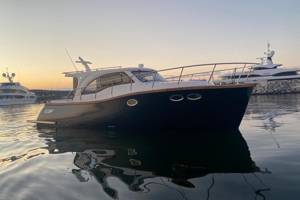 2024 Erman Lobster 34 yacht at sunset, docked in a serene marina.