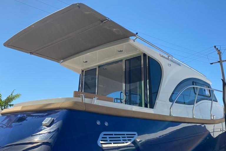 2024 Erman Lobster 34 boat with sleek design and modern features under clear blue sky.