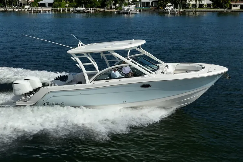  Yacht Photos Pics 2020 Robalo R317 Dual Console boat cruising on a serene lake.