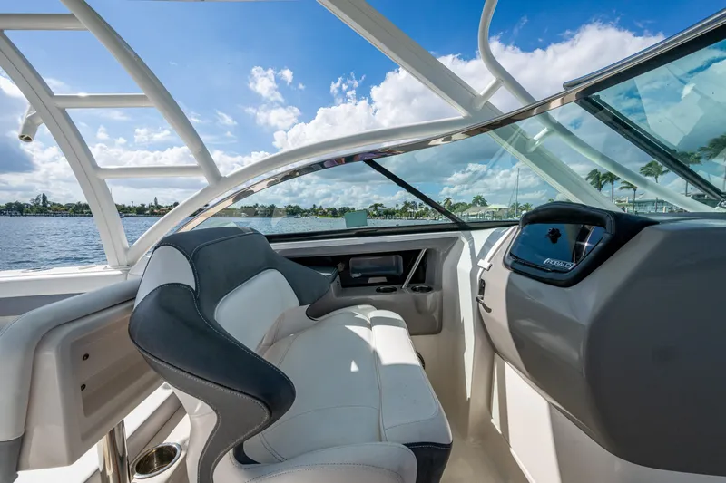  Yacht Photos Pics 2020 Robalo R317 Dual Console boat interior with helm and seating, under blue sky.