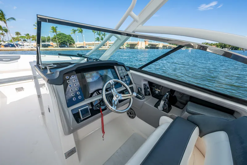  Yacht Photos Pics 2020 Robalo R317 Dual Console boat interior with steering wheel and control panel.