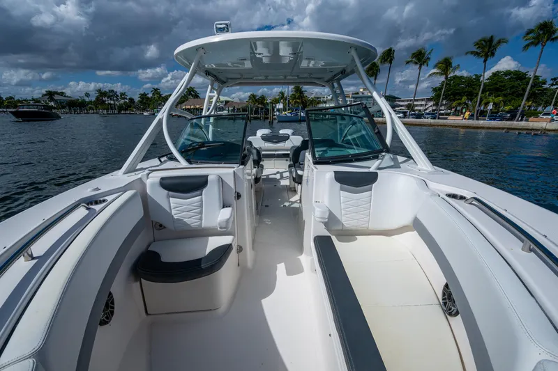  Yacht Photos Pics 2020 Robalo R317 Dual Console boat interior with seating, on a sunny day by the water.