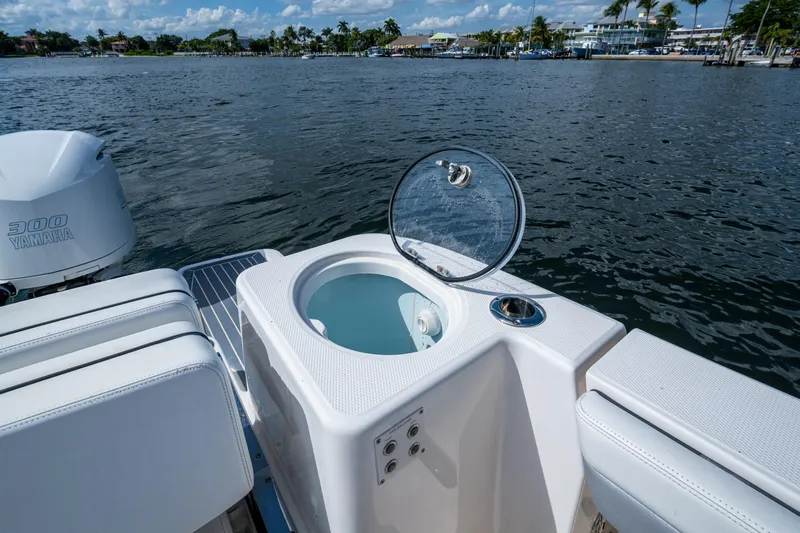  Yacht Photos Pics 2020 Robalo R317 Dual Console boat with open livewell and Yamaha 300 engine on water.