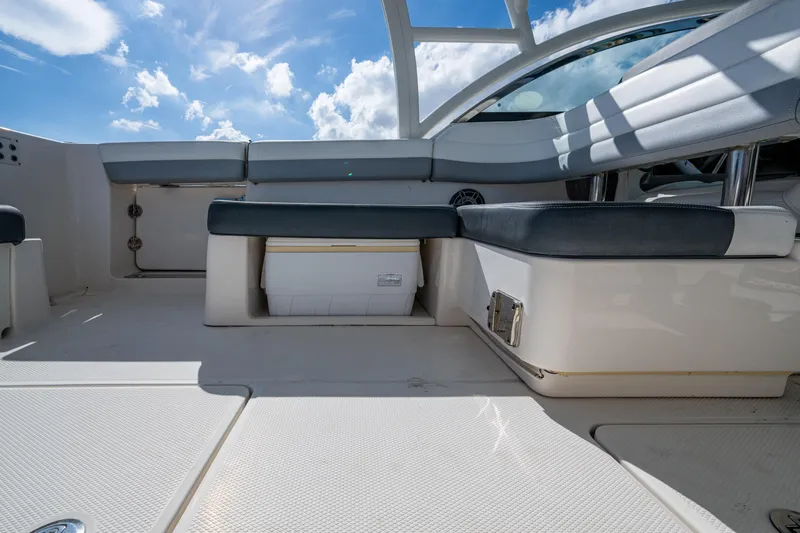  Yacht Photos Pics 2020 Robalo R317 Dual Console boat interior with cushioned seating and storage under a sunny sky.