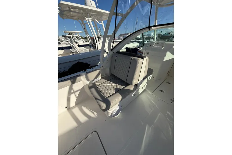  Yacht Photos Pics 2024 Pursuit DC 246 Dual Console interior with cushioned seating and sleek design.