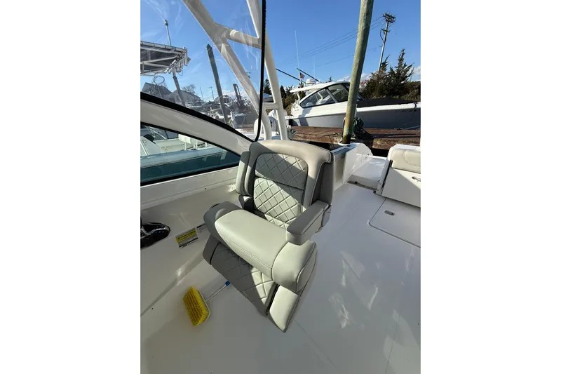  Yacht Photos Pics 2024 Pursuit DC 246 Dual Console boat interior with cushioned seating.