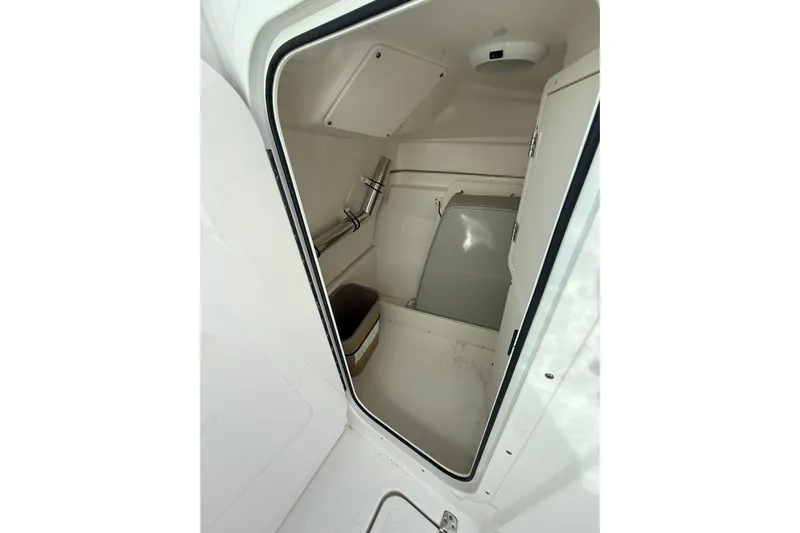  Yacht Photos Pics 2024 Pursuit DC 246 Dual Console interior storage compartment with sleek design and practical features.