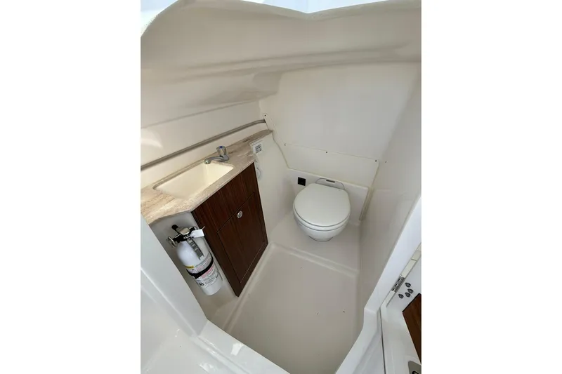  Yacht Photos Pics 2024 Pursuit DC 246 Dual Console boat interior with sink, toilet, and fire extinguisher.