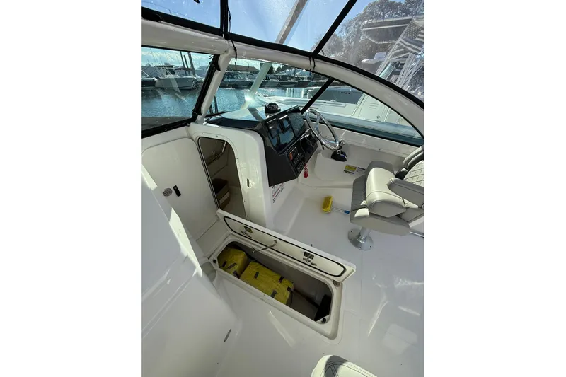  Yacht Photos Pics 2024 Pursuit DC 246 Dual Console interior with helm, seating, and storage compartments.