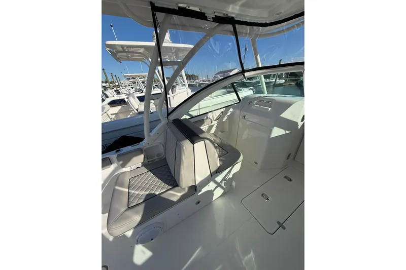  Yacht Photos Pics 2024 Pursuit DC 246 Dual Console boat interior with seating and dashboard view.