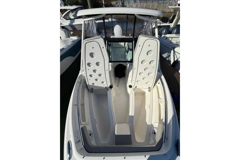  Yacht Photos Pics 2024 Pursuit DC 246 Dual Console boat interior with open storage compartments.