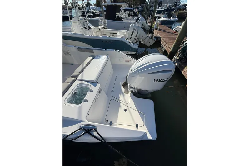  Yacht Photos Pics 2024 Pursuit DC 246 Dual Console with Yamaha outboard engine at dock.