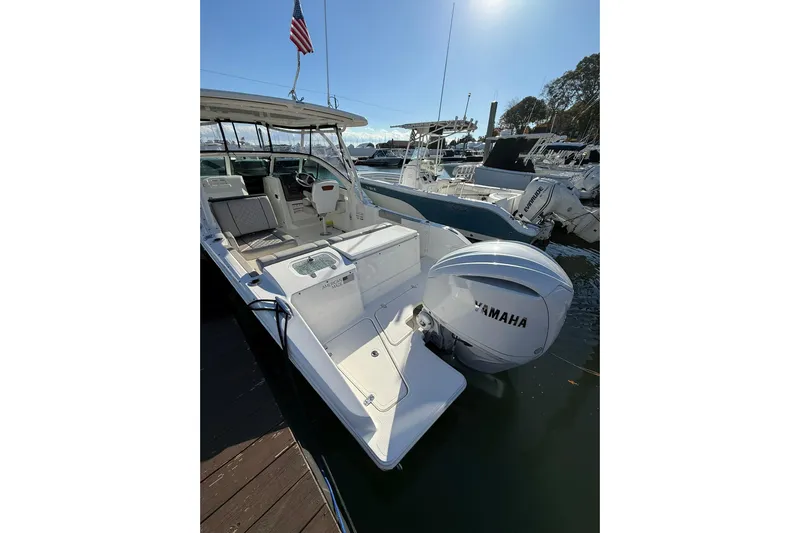  Yacht Photos Pics 2024 Pursuit DC 246 Dual Console boat with Yamaha engine docked at marina.