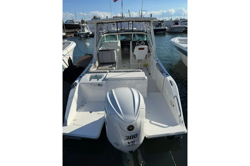  Yacht Photos Pics 2024 Pursuit DC 246 Dual Console boat with powerful 300 HP engine, docked in marina.