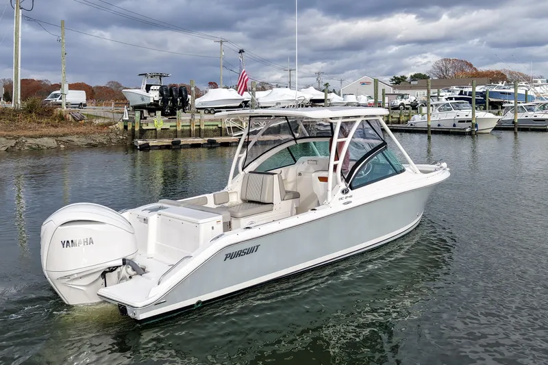 Yacht Photos Pics 2024 Pursuit DC 246 Dual Console boat on water, featuring Yamaha engine.