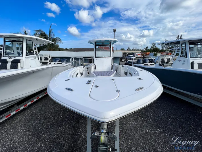  Yacht Photos Pics 2024 Tidewater 272 CC Adventure boat displayed outdoors under a blue sky.