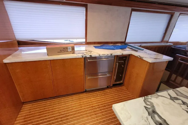 Island Dancer Yacht Photos Pics Interior of 2000 Hatteras 75 Sport Deck Motor Yacht with marble countertops and wooden cabinetry.