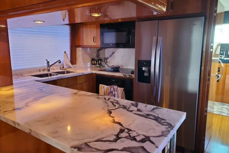 Island Dancer Yacht Photos Pics Luxurious kitchen interior of 2000 Hatteras 75 Sport Deck Motor Yacht with marble countertops.