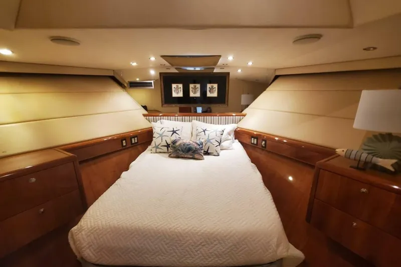Island Dancer Yacht Photos Pics Luxurious bedroom interior of 2000 Hatteras 75 Sport Deck Motor Yacht with elegant wood finish.