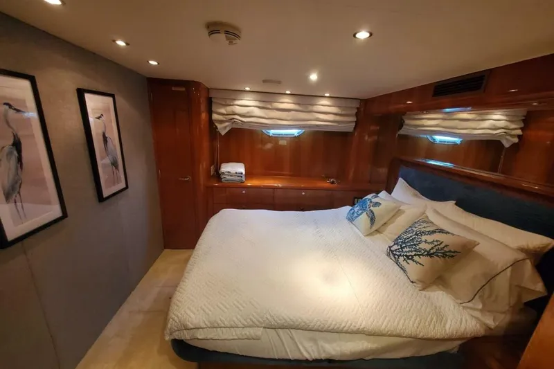 Island Dancer Yacht Photos Pics Luxurious bedroom interior of 2000 Hatteras 75 Sport Deck Motor Yacht with elegant decor.