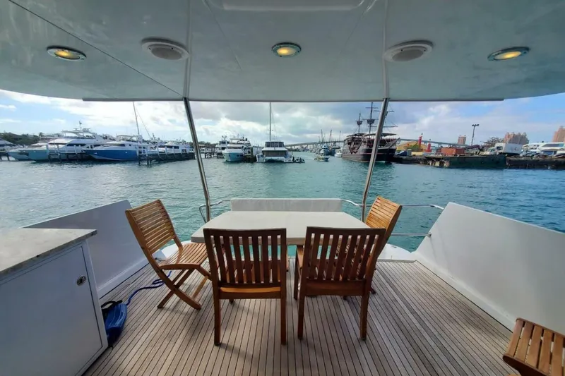 Island Dancer Yacht Photos Pics Aft deck of 2000 Hatteras 75 Sport Deck Motor Yacht with marina view.