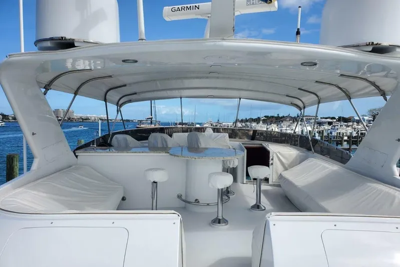 Island Dancer Yacht Photos Pics Luxurious 2000 Hatteras 75 Sport Deck Motor Yacht with spacious outdoor seating and ocean view.