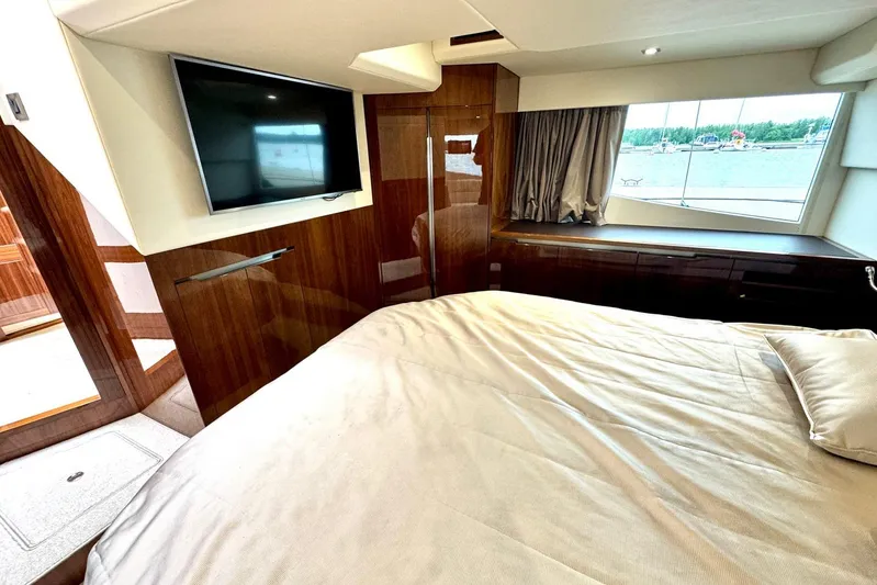  Yacht Photos Pics Luxurious bedroom interior of 2018 Galeon 470 Skydeck yacht with TV and window view.