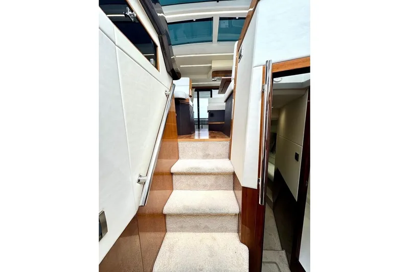  Yacht Photos Pics Interior staircase of 2018 Galeon 470 Skydeck yacht, featuring modern design and wood accents.