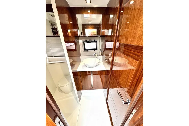  Yacht Photos Pics Luxurious bathroom interior of 2018 Galeon 470 Skydeck yacht with modern fixtures.