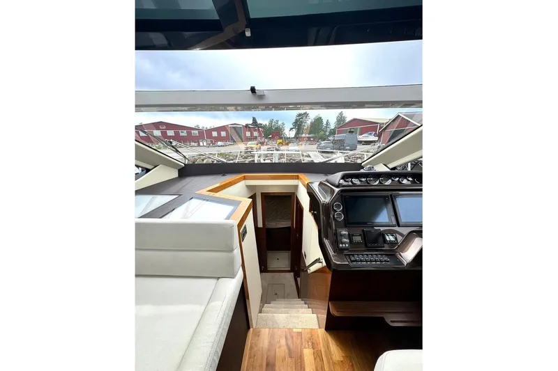  Yacht Photos Pics Interior view of 2018 Galeon 470 Skydeck yacht with modern dashboard and scenic window view.