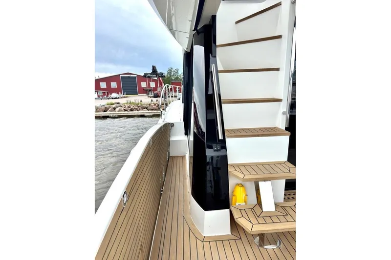  Yacht Photos Pics 2018 Galeon 470 Skydeck yacht with wooden deck and staircase, dockside view.