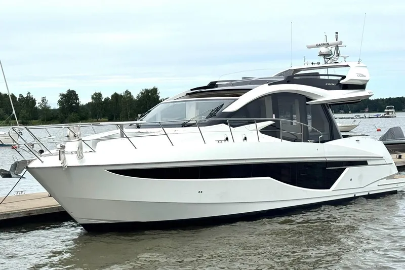  Yacht Photos Pics 2018 Galeon 470 Skydeck yacht docked on a calm lake.