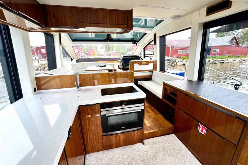  Yacht Photos Pics Luxurious interior of 2018 Galeon 470 Skydeck yacht with modern kitchen and seating area.