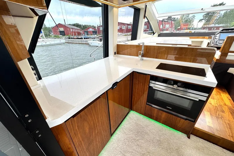  Yacht Photos Pics Luxurious kitchen interior of 2018 Galeon 470 Skydeck yacht with modern appliances.