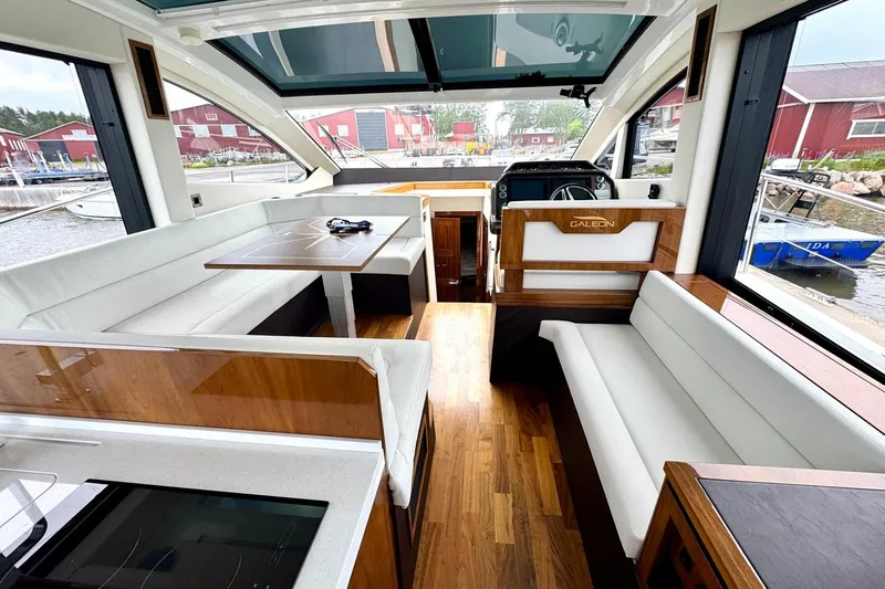  Yacht Photos Pics Luxurious interior of 2018 Galeon 470 Skydeck yacht with elegant seating and wooden accents.