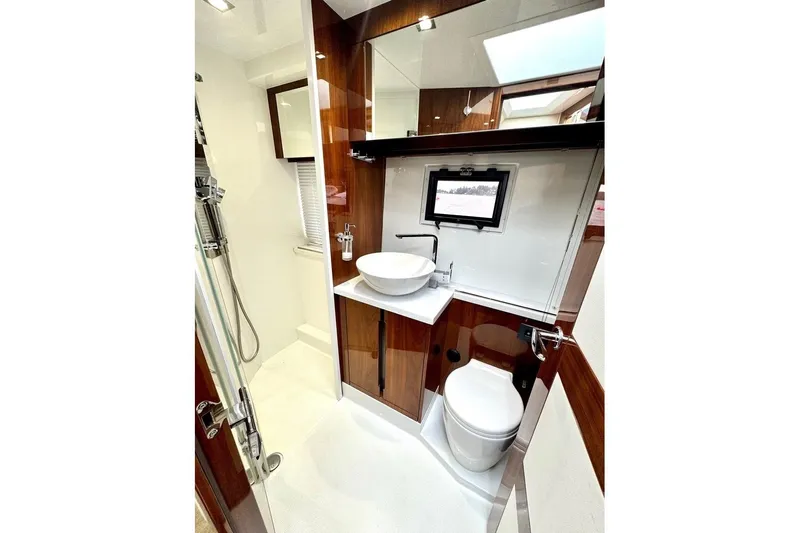  Yacht Photos Pics Luxurious bathroom in 2018 Galeon 470 Skydeck yacht with modern fixtures and elegant design.