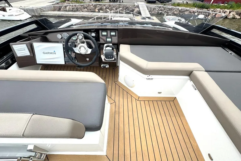  Yacht Photos Pics 2018 Galeon 470 Skydeck yacht interior with Garmin navigation system and sleek seating.