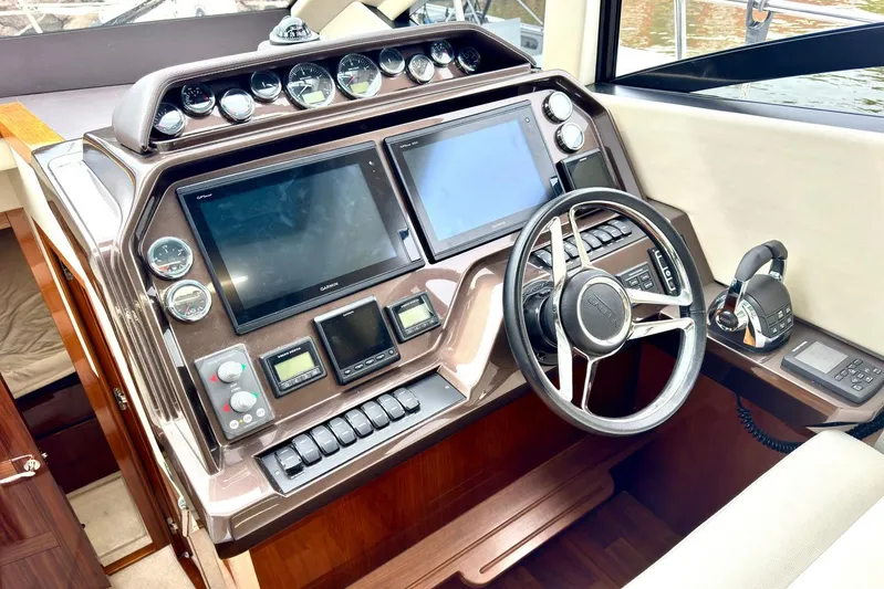  Yacht Photos Pics 2018 Galeon 470 Skydeck helm with dual screens and modern controls.