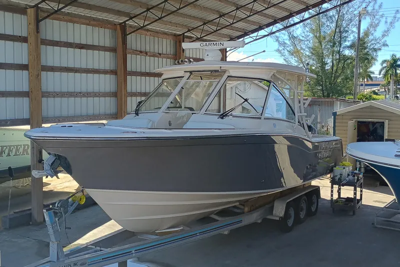 325-708 Brokerage Josh Yacht Photos Pics 2021 Grady-White Freedom 325 boat on trailer in covered storage area.