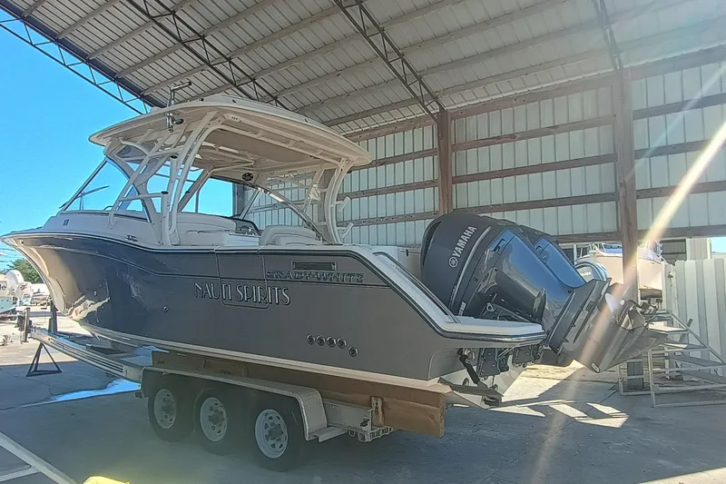 325-708 Brokerage Josh Yacht Photos Pics 2021 Grady-White Freedom 325 boat on trailer in covered storage.