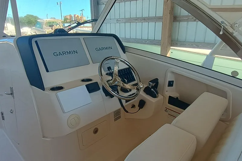 325-708 Brokerage Josh Yacht Photos Pics 2021 Grady-White Freedom 325 helm with dual Garmin displays and steering wheel.